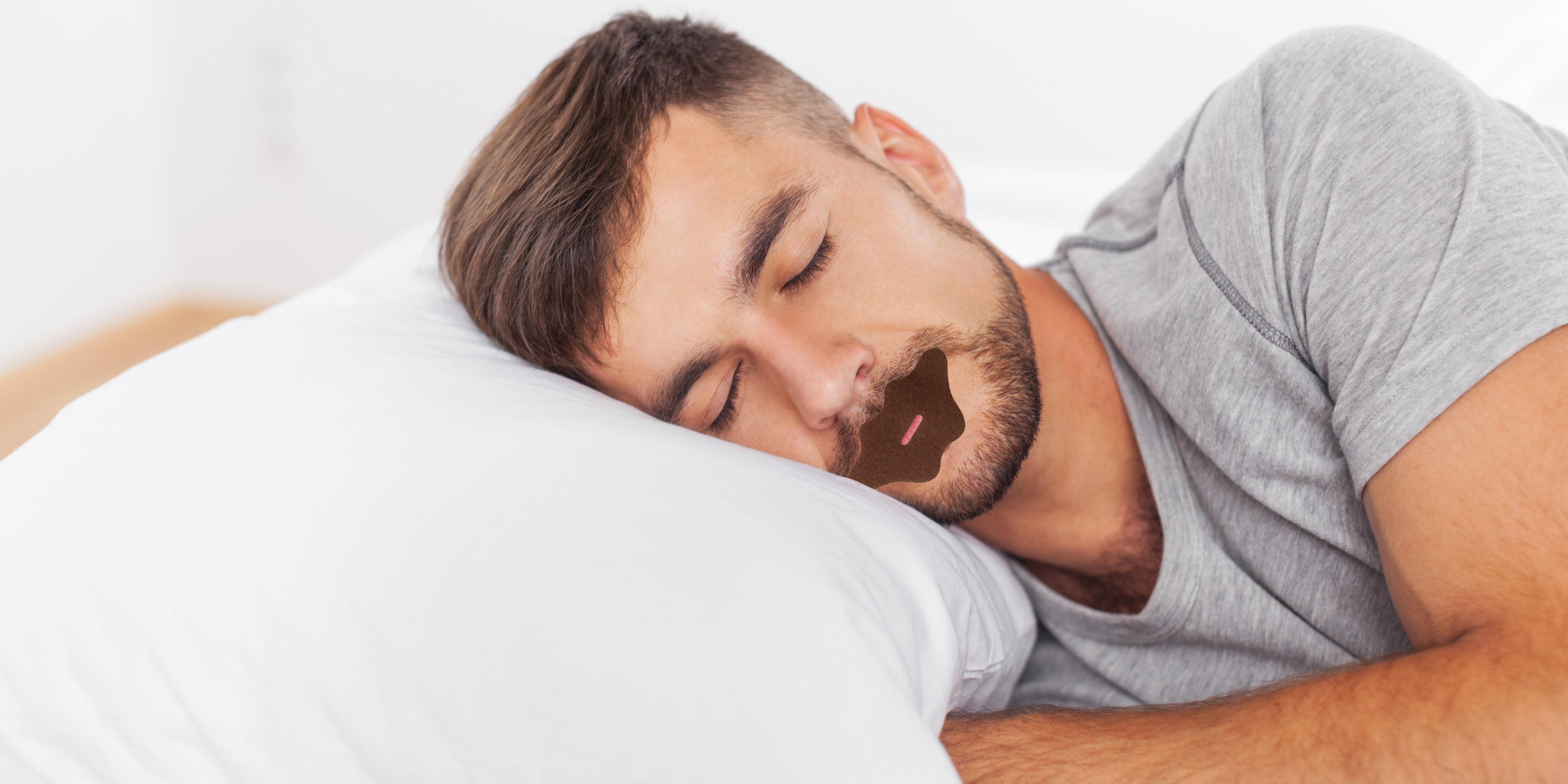 Man sleeping peacefully with WELLPA mouth tape applied for better nasal breathing and improved sleep quality